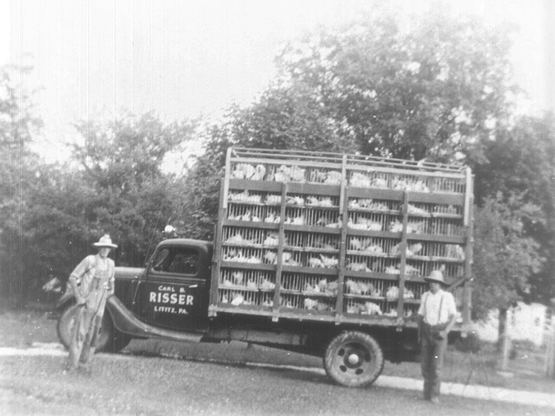 Black and white photo of an old Carl B. Risser chicken truck