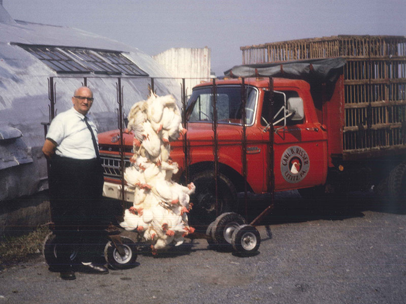 Photo of Carl B. Risser in 1965 with his patented cart system for leading birds